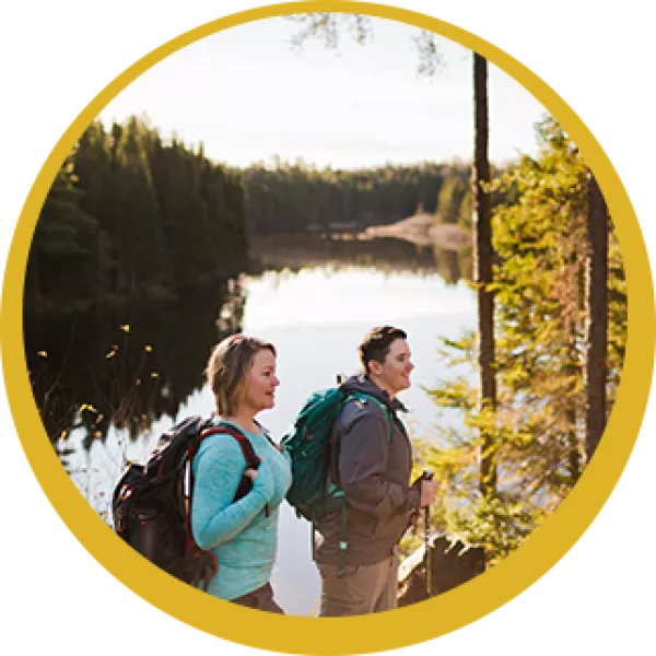 Two people hike a trail