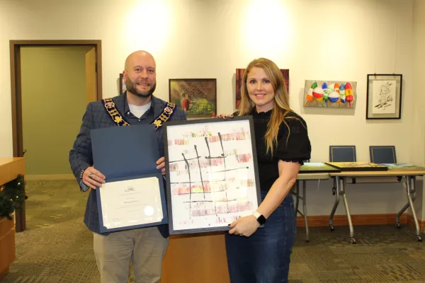 Artist and mayor standing together with painting