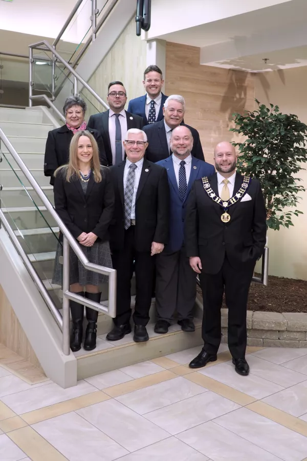 Town council gathered on steps smiling