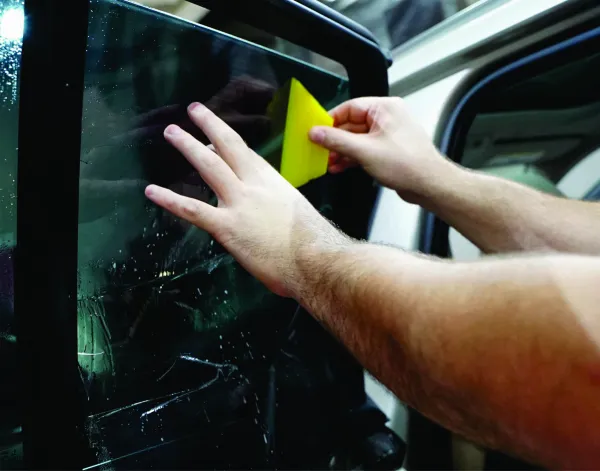 Car window being covered with tint.