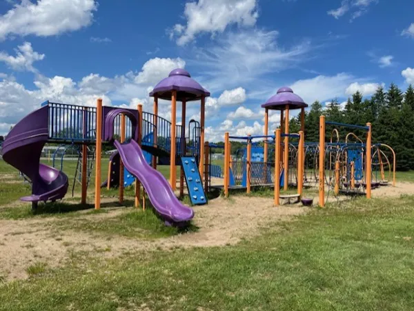 Playground with cloudy blue skies in the background. 