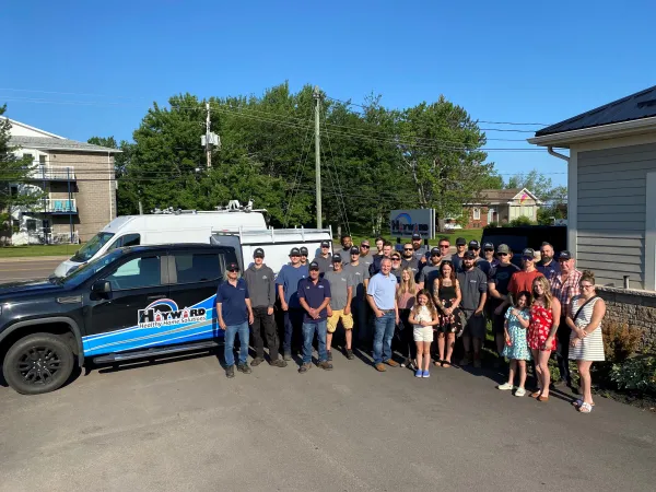 Team from hayward stand beside truck outside their office