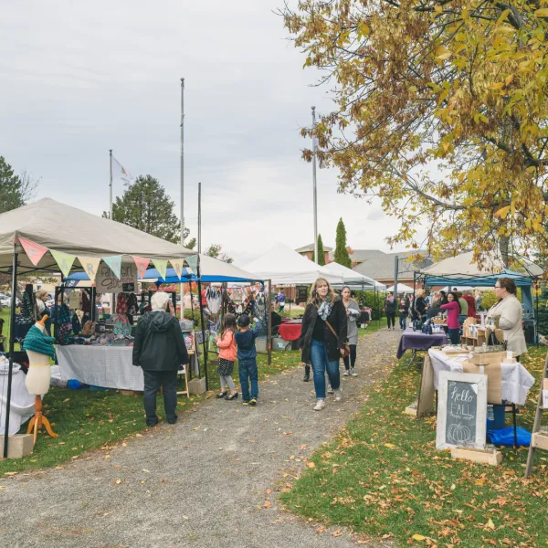 Outdoor market vendors set up on a fall day in the park