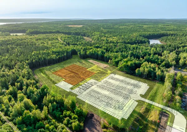 Aerial view of a map overlay on a wooded area for future building