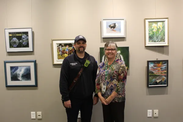 service award winners stand in front of artwork