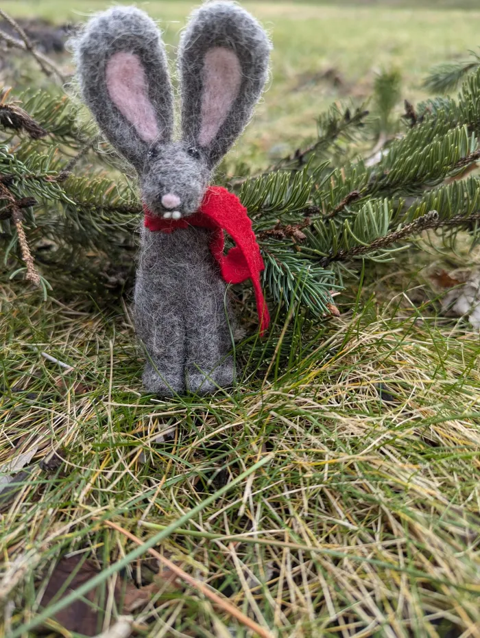 Needle felted winter bunny in the grass.