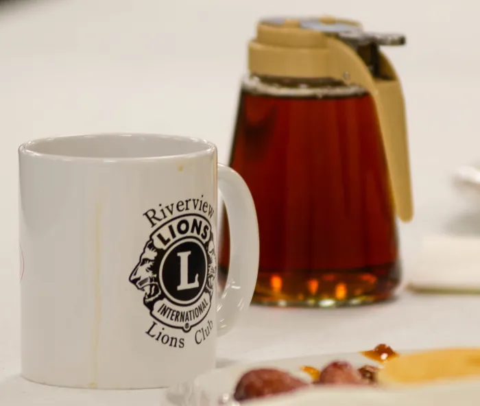 Riverview Lion's Club coffee mug, pitcher of maple syrup