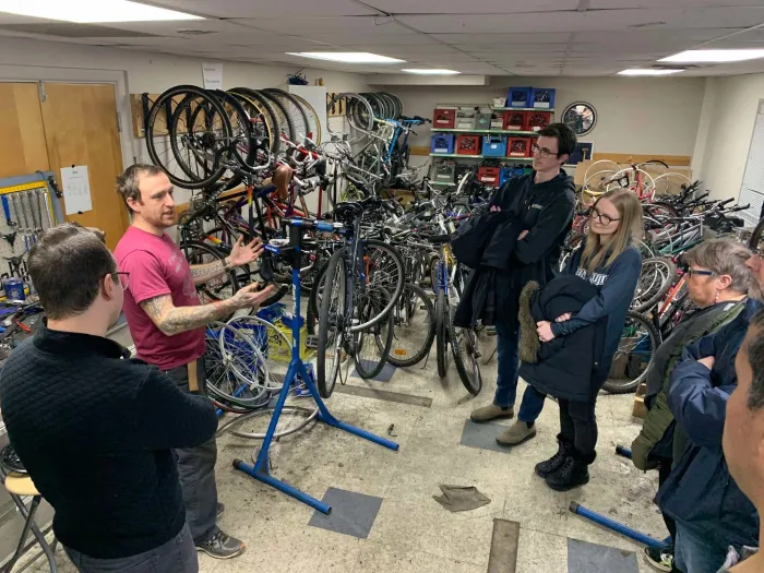 People receiving instruction on bike repair